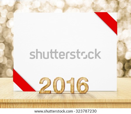 white poster with red ribbon and 2016 year wood texture with sparkling gold bokeh wall and wooden table