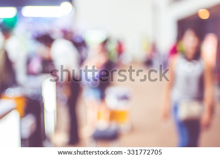 Blurred background: crowd of people in expo fair with bokeh light ,Vintage filter