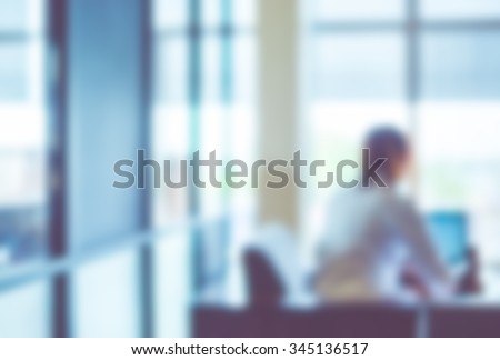 Blurred background : officer working on computer at office building,Business background with vintage filter