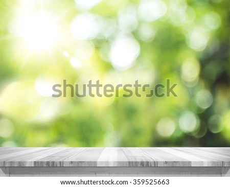 Empty white wood table top with blur green tree bokeh background, Template mock up for montage of product