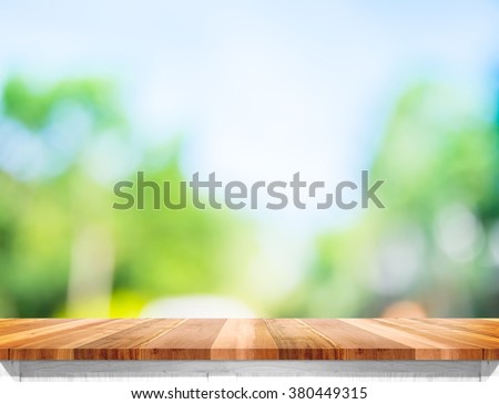 Empty brown wood table top with sun and blur green tree bokeh background, Template mock up for montage of product