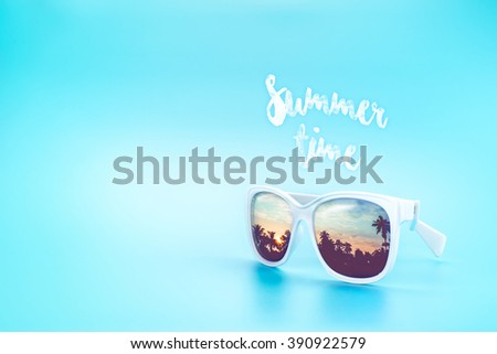 White Sunglasses reflection sunset at palm tree landscape scene in light blue studio,Summer Time concept,Leave space for adding your content or text