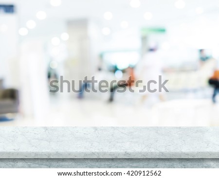 Empty white marble table top with blur patient waiting for doctor at hospital with bokeh light at background, Mock up for display or montage of product