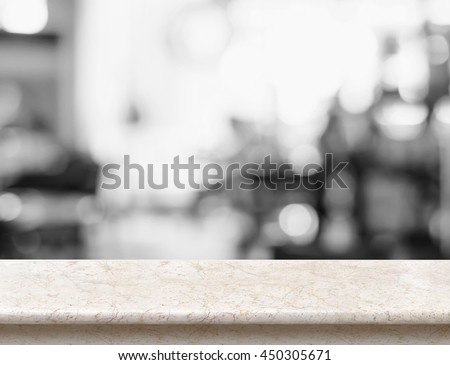 Empty beige marble table top with black and white people siting at cafe blurred background,Mock up scene for display or montage of product