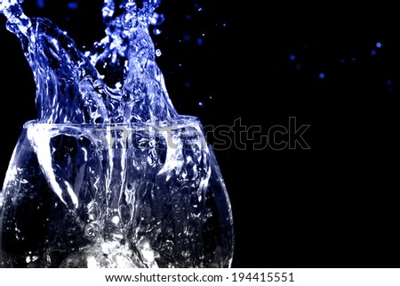 water Splash from the glass isolated on black background