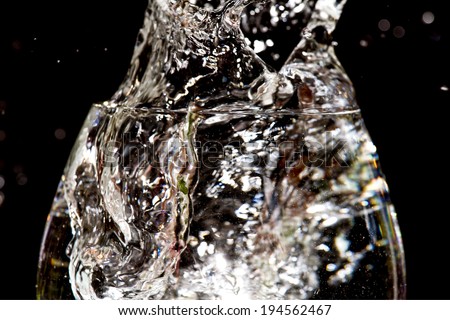 water Splash from the glass isolated on black background