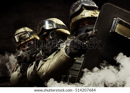 The man in the image of a member of the special forces with weapons