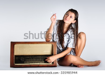 Pretty girl listening music on the radio isolated on white background