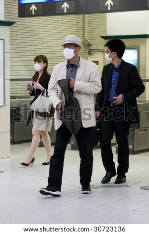 KOBE, JAPAN - MAY 20: People on the street wear face masks because of the outbreak of swine flu, Sannomiya JR station on May 20, 2009 in Kobe, Japan.