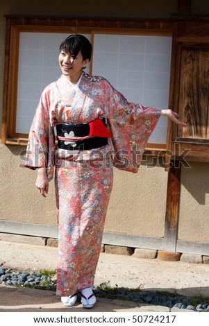KOBE, JAPAN - APRIL 10: Japanese woman in kimono gestures for a tea ceremony at Akashi Castle on April 10, 2010 in Kobe, Japan.