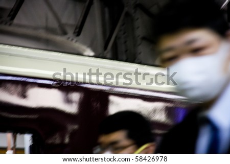 KOBE, JAPAN - MAY 20: People on the street wear face masks because of the outbreak of swine flu near Sannomiya JR station May 20, 2009 Kobe