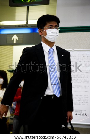 KOBE, JAPAN - MAY 20: People at the station wear face masks because of the outbreak of swine flu near Sannomiya JR station May 20, 2009 in Kobe, Japan.
