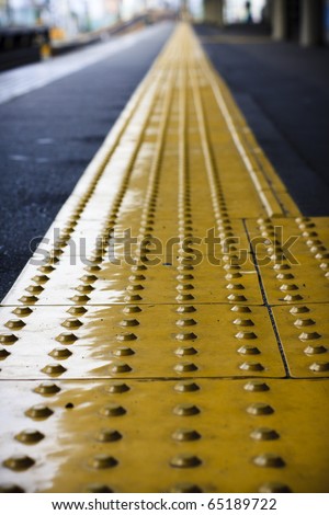 Perspective yellow tactile strip for cane or foot of blind person, Japan