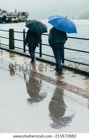 People with umbrella walking in the street on a rainy day