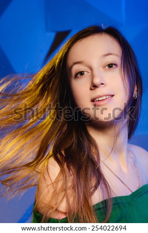 Portrait of beautiful young woman with fluttering hair
