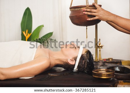 Caucasian woman having Ayurveda shirodhara treatment in India