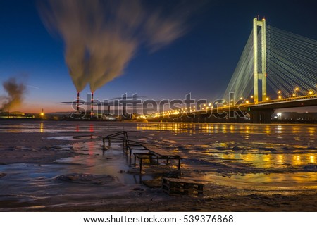 Smog from power plant near the Dnipro river on night city background, Kiev, Ukraine. Air pollution concept