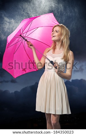 Slim blonde woman with bright pink umbrella