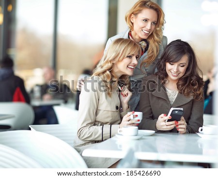Three cheerful girlfriends enjoying their spare time