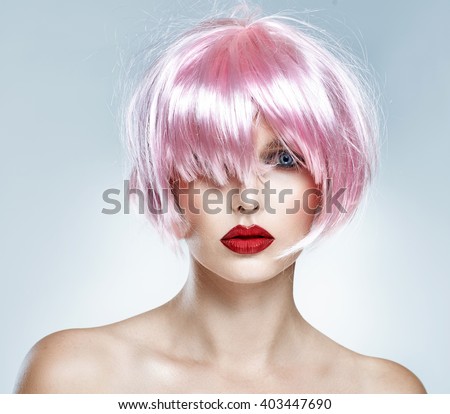 Portrait of glamour girl with red lips and pink hair isolated on blue background