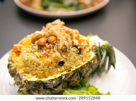 Freshly prepared pineapple fried rice served inside of a pineapple carved like a bowl