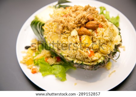 Freshly prepared pineapple fried rice served inside of a pineapple carved like a bowl