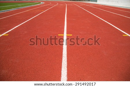 white and yellow line on red track texture background