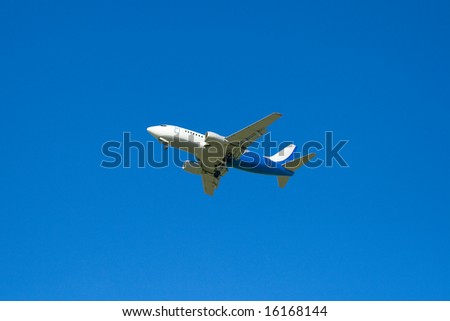 The passenger plane on a background of the dark blue sky