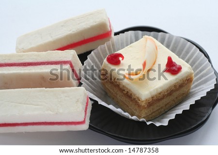 cake on black plate and white fruit candy