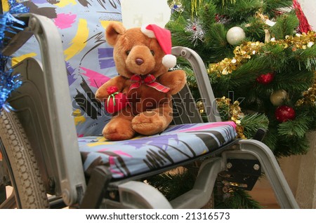 Teddy bear in the children`s wheelchair