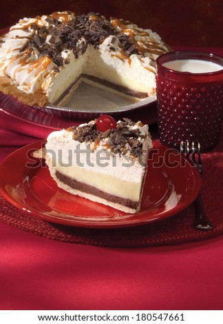 Brownie Custard Pie Slice Topped with Chocolate Bits On Red Background With Pie and Glass of Milk