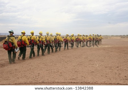fire crew marching in line towards a fire