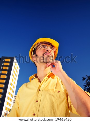 construction worker looking upward and thinking