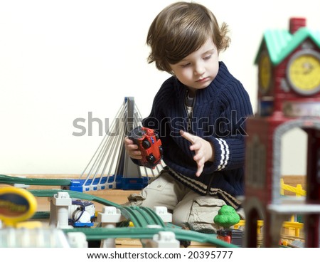 little boy playing with his new train set. Shallow DOF.