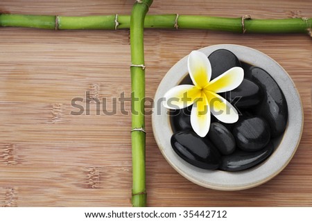 Spa still life background, with flower, bamboo and massage stones