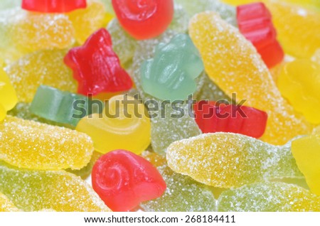 Sour colored jelly candy and sweet shaped like a shell background