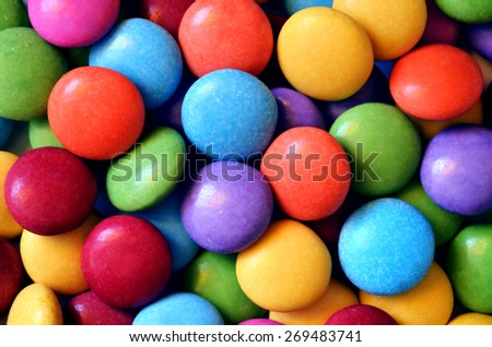 Macro detail of pile of colored smarties background