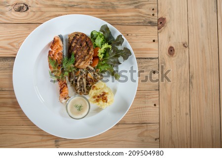 salmon steak white sauce on wood table