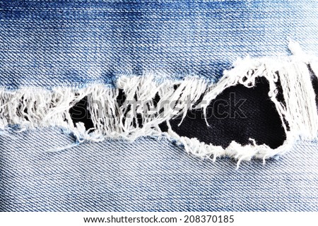 Blue denim jeans tear up present the old damaging fabric damaged detail.