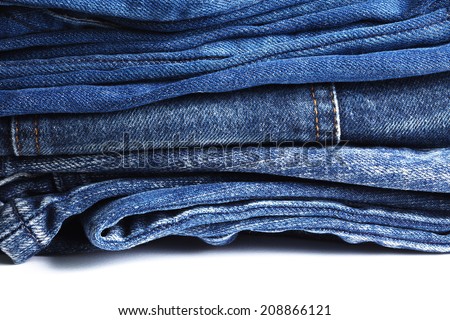 Blue denim jeans many pairs in dark color tone fold and stack up together.