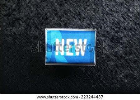 Acrylic stand with the word new represent as a sign display for customer to know the new products