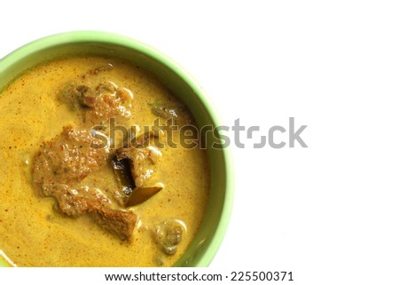 Pork yellow curry with turmeric powder in green bowl represent Thai cuisine and spicy curry with real southern Thai traditional food style