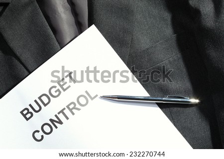 Grey color suit represent the formal uniform for businessman in the scene appear chrome ball pen and printed business related wording term on the paper also