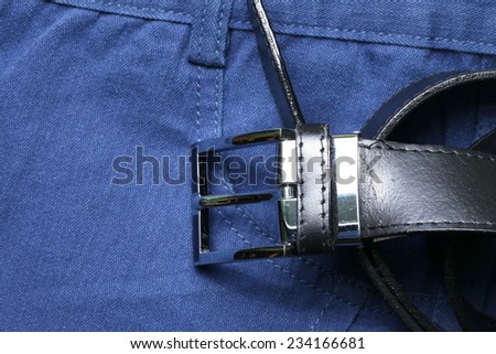 Blue color of short trouser made from herringbone patterned fabric style represent the applied synthetic cloth production in the scene appear the black color leather belt business style  also