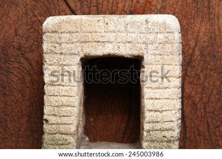 Old and vintage surface texture of sand stone pavilion wall and window architectural sculpture model with moss stain represent the texture and surface background.