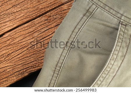 Short pant pocket in the scene appear the hard wood brown color and black color leather is a background represent the uniform concept idea.