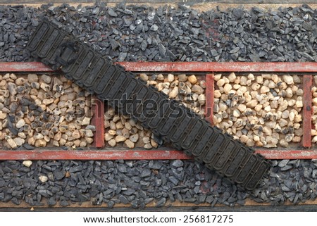 Damaged model of wheeled  tractors put on vintage old model of railway track and stone ballast for railway track represent the railway transportation equipment.