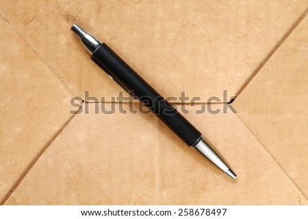 Luxury ball pen put on the old paper texture surface background represent the writing equipment related.