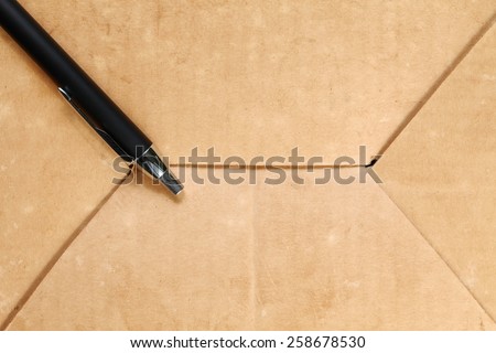 Luxury ball pen put on the old paper texture surface background represent the writing equipment related.