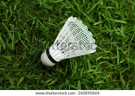 Shuttle cock plastic type put on the grass background represent the badminton sport equipment related concept idea.
